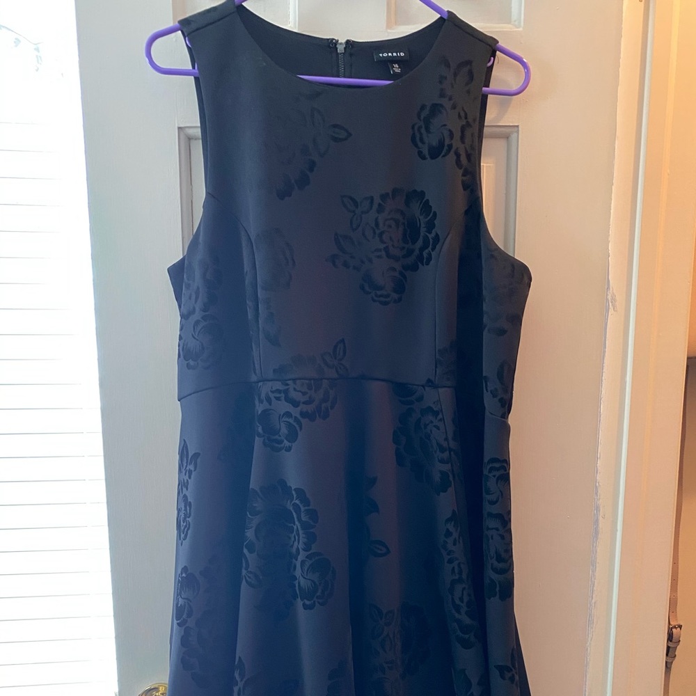 Black dress with scoop neck and sleeves.